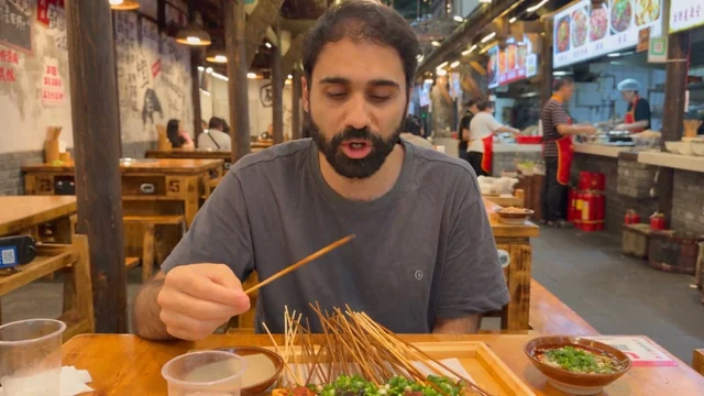 Beat 5: he looks at the bare skewer in his hand and speaks.