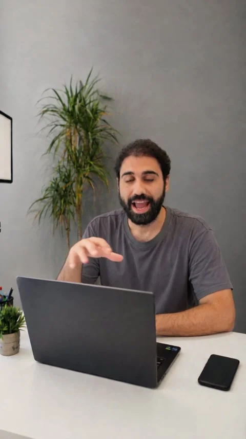 Vertical render from the same prompt: the man at the same desk, framed wider, smaller in the frame, the plant centred behind him.