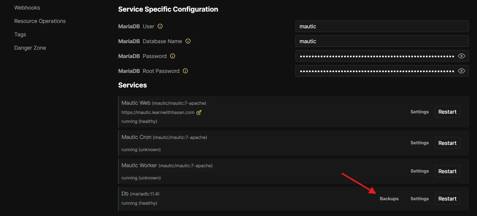 Coolify Mautic stack configuration showing the Services section with Mautic Web, Mautic Cron, Mautic Worker, and the Db (mariadb:11.4) service. A red arrow points to the Backups link next to the Db service.