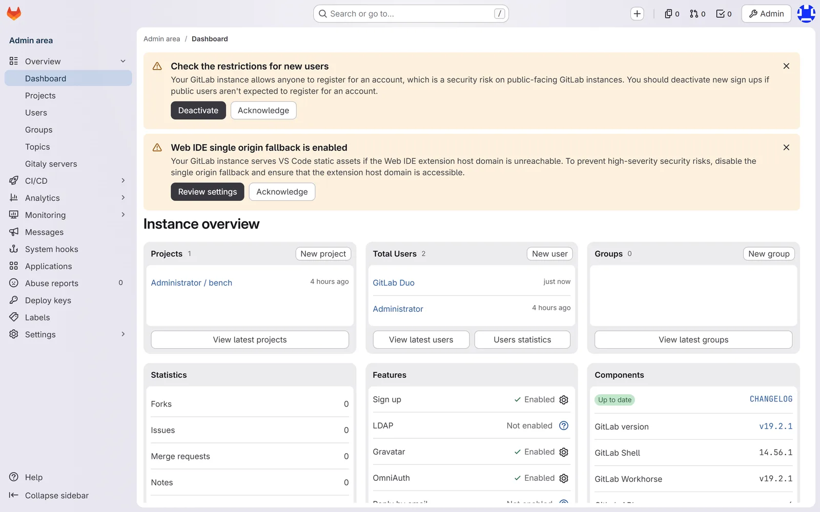 GitLab admin dashboard of the fresh instance showing version 19.2.1 in the components list and a security warning banner saying that anyone can register for an account, with a Deactivate button.